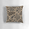 Pastel gold pillow with a geometric animal print design featuring leopard and zebra patterns.