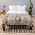 Pastel gold plush blanket featuring Egyptian hieroglyphics design