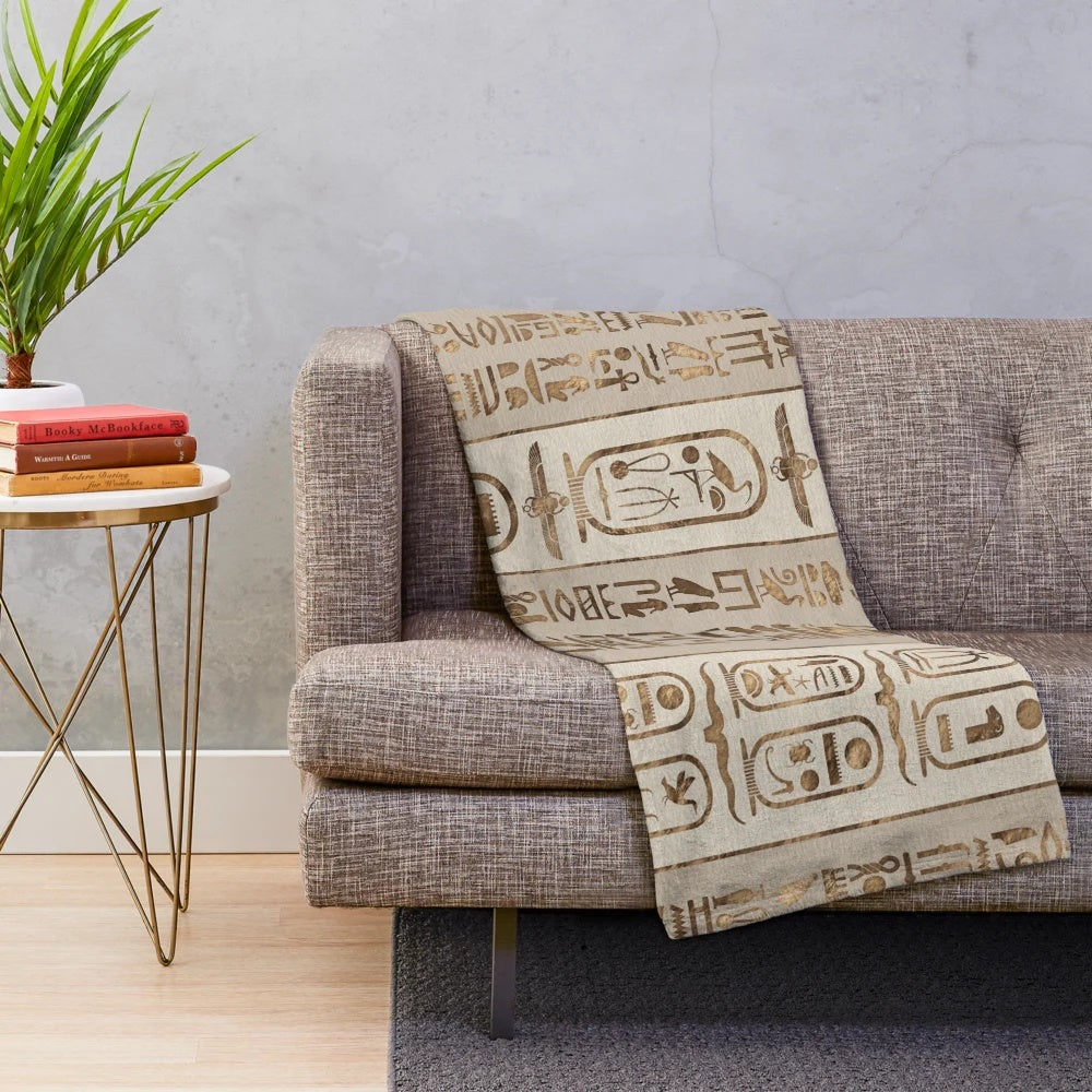 Pastel gold plush blanket featuring Egyptian hieroglyphics design