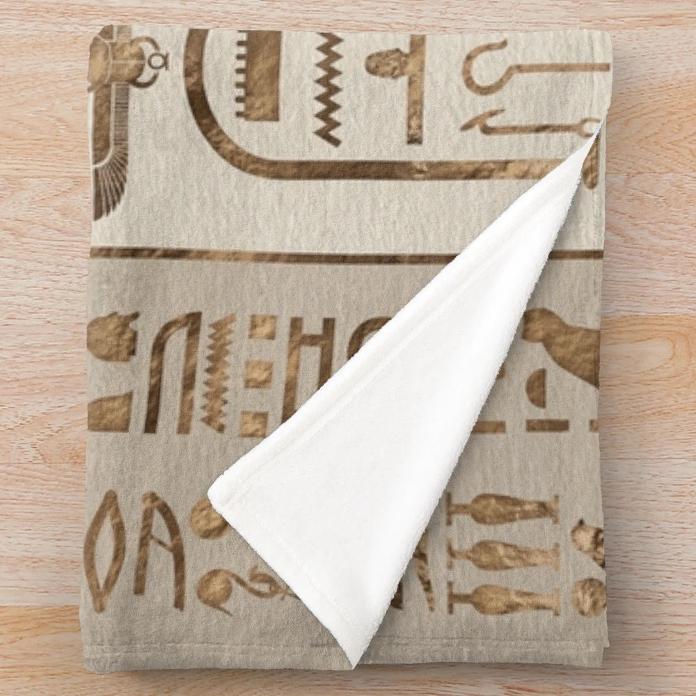 Pastel gold plush blanket featuring Egyptian hieroglyphics design