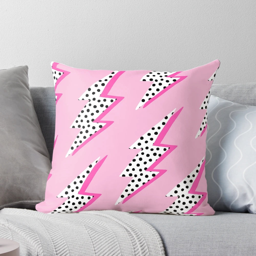Pastel pink pillow with a graphic lightning bolt design
