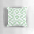 Pastel green and white checkered decorative pillow with a geometric floral pattern