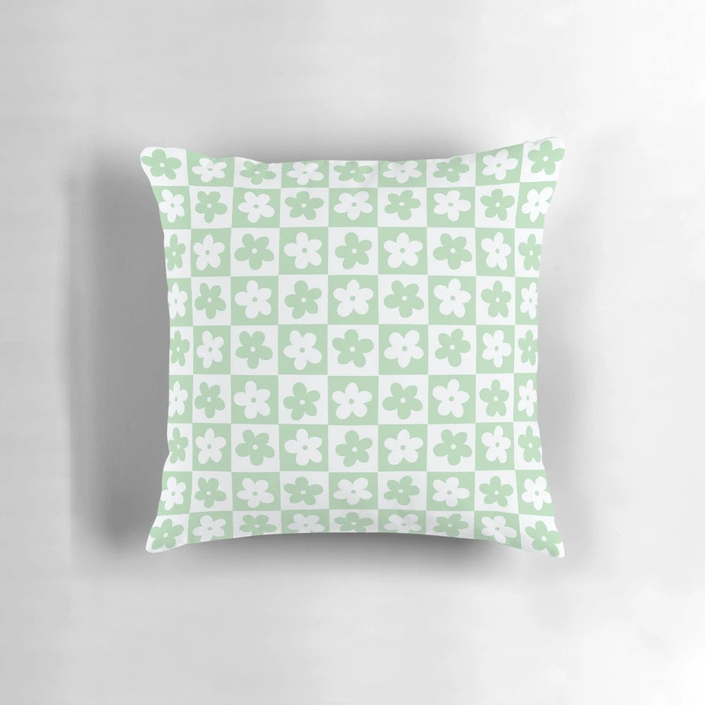 Pastel green and white checkered decorative pillow with a geometric floral pattern