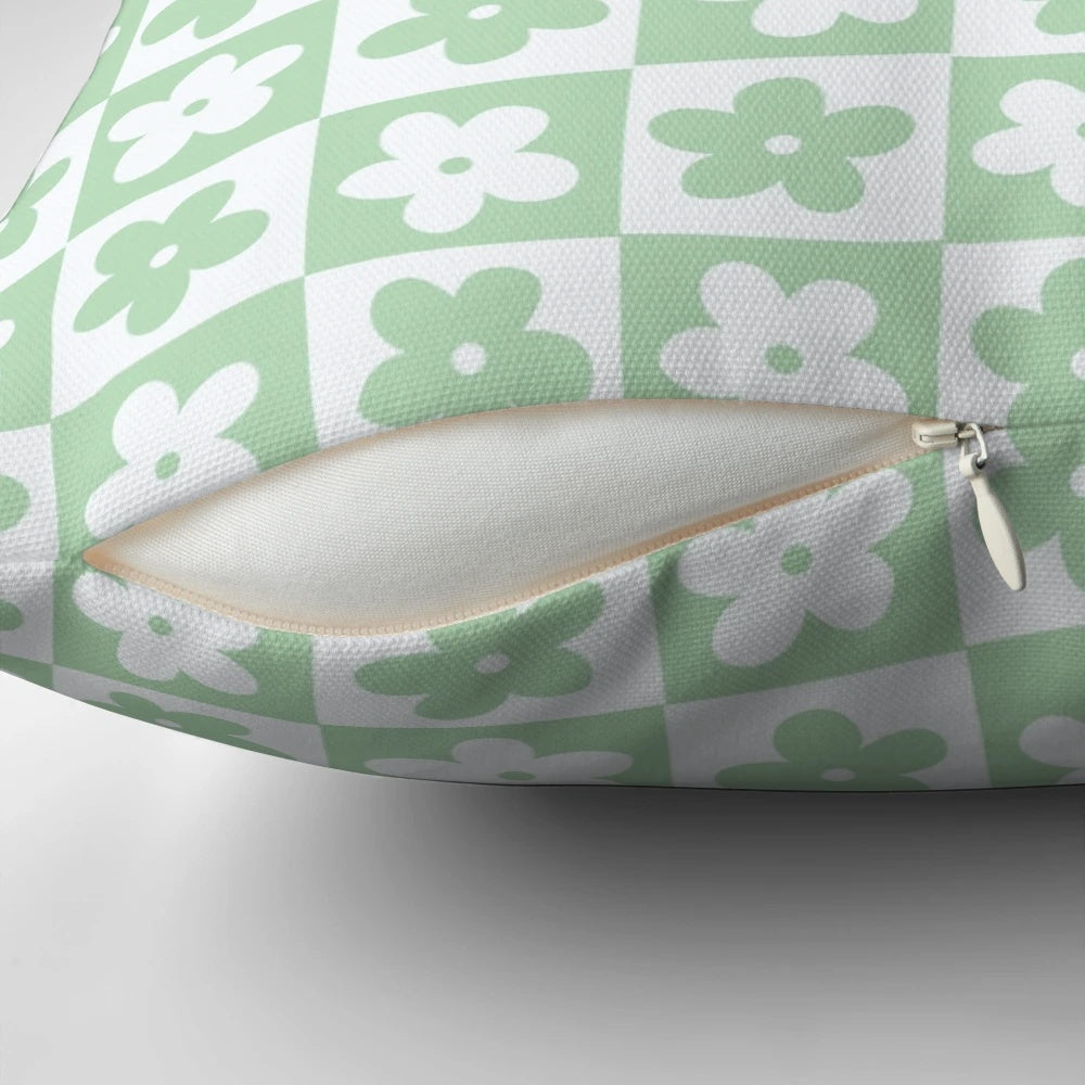 Pastel green and white checkered decorative pillow with a geometric floral pattern