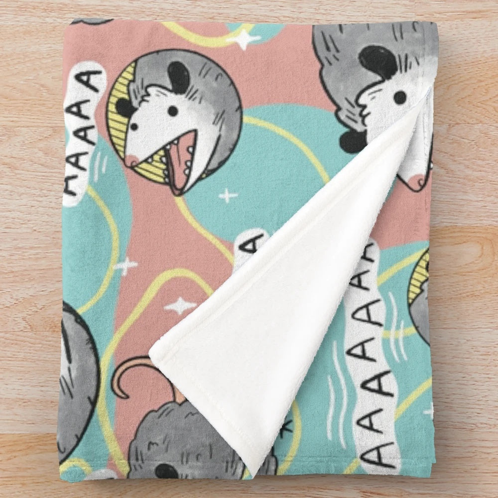 Pastel colored plush blanket featuring a cute opossum making the "screm" meme face