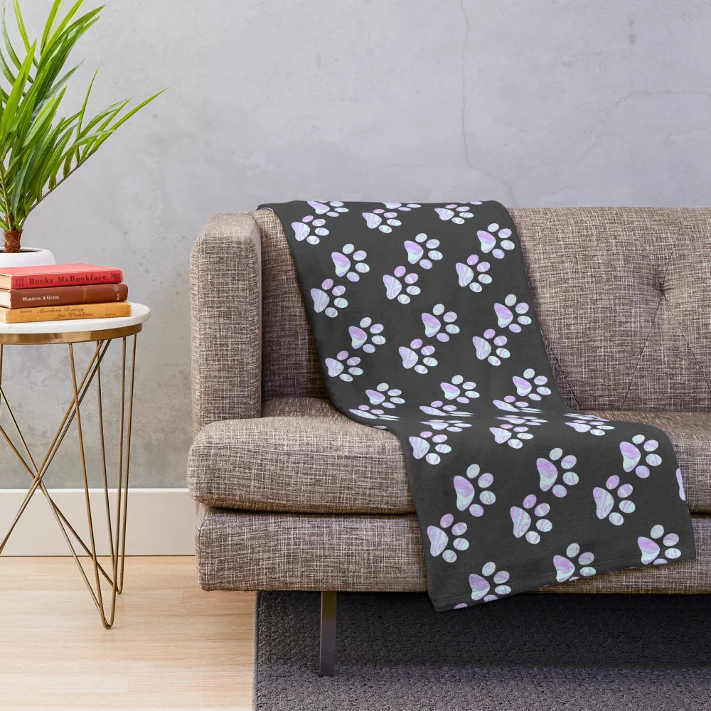Pastel paw print plush blanket with a holographic, opal, and iridescent design