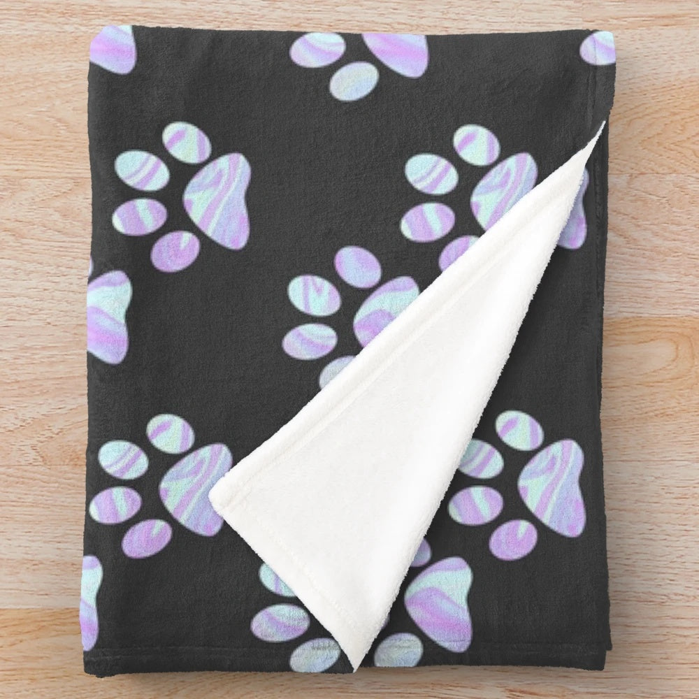 Pastel paw print plush blanket with a holographic, opal, and iridescent design