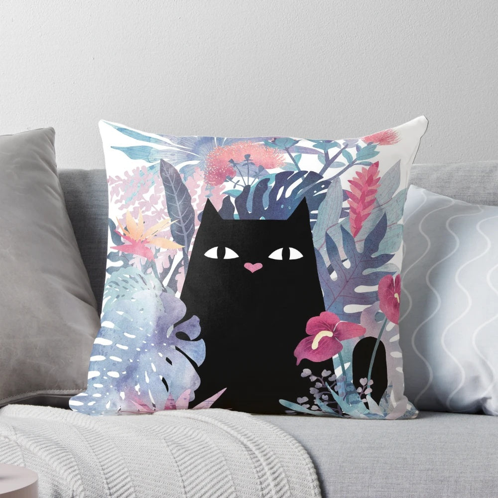 Pastel pillow featuring a whimsical black cat surrounded by tropical foliage and flowers