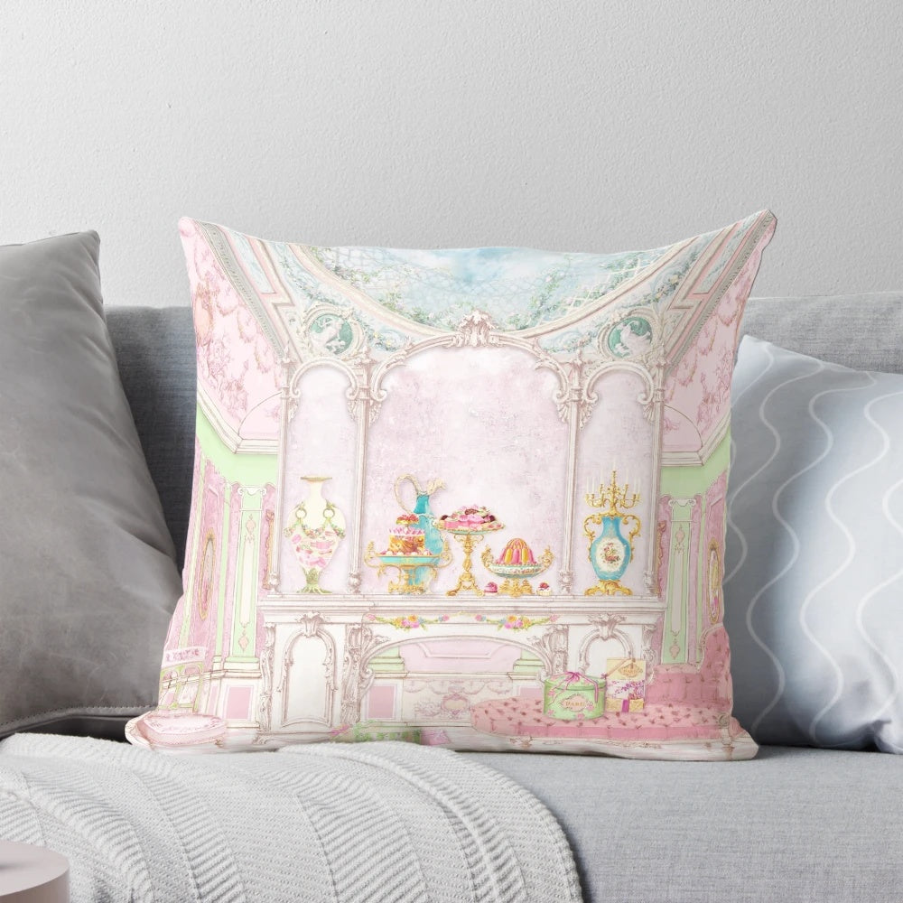 Soft pink pillow with a watercolor illustration of a French patisserie and diorama scene, featuring a Marie Antoinette-inspired cake shop.