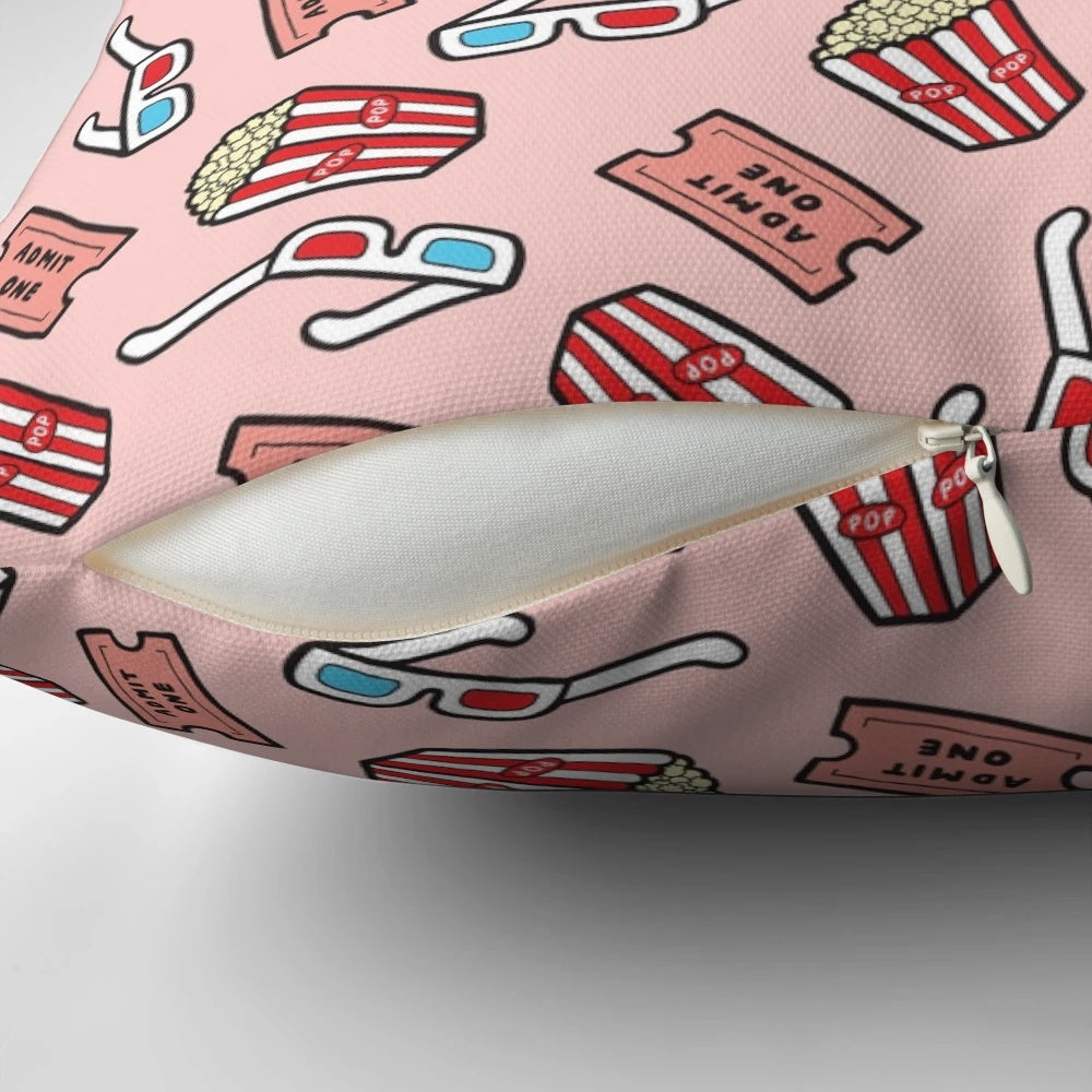 Pastel pink throw pillow with a stylized movie pattern design, featuring popcorn, movie glasses, and a retro 80s aesthetic.