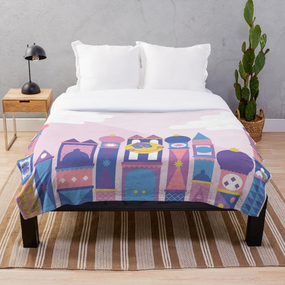 Pastel colored plush blanket with a Disney-inspired cartoon building design
