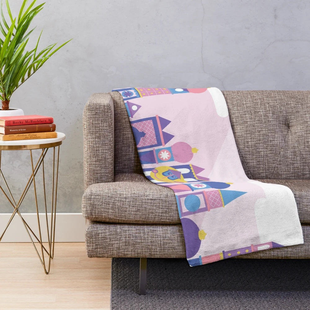 Pastel colored plush blanket with a Disney-inspired cartoon building design