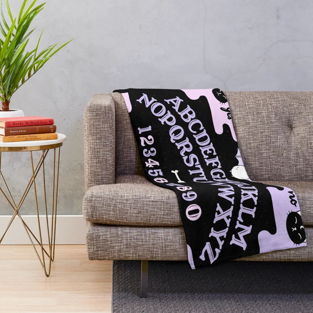 Pastel plush blanket with occult, witchy, and spooky design