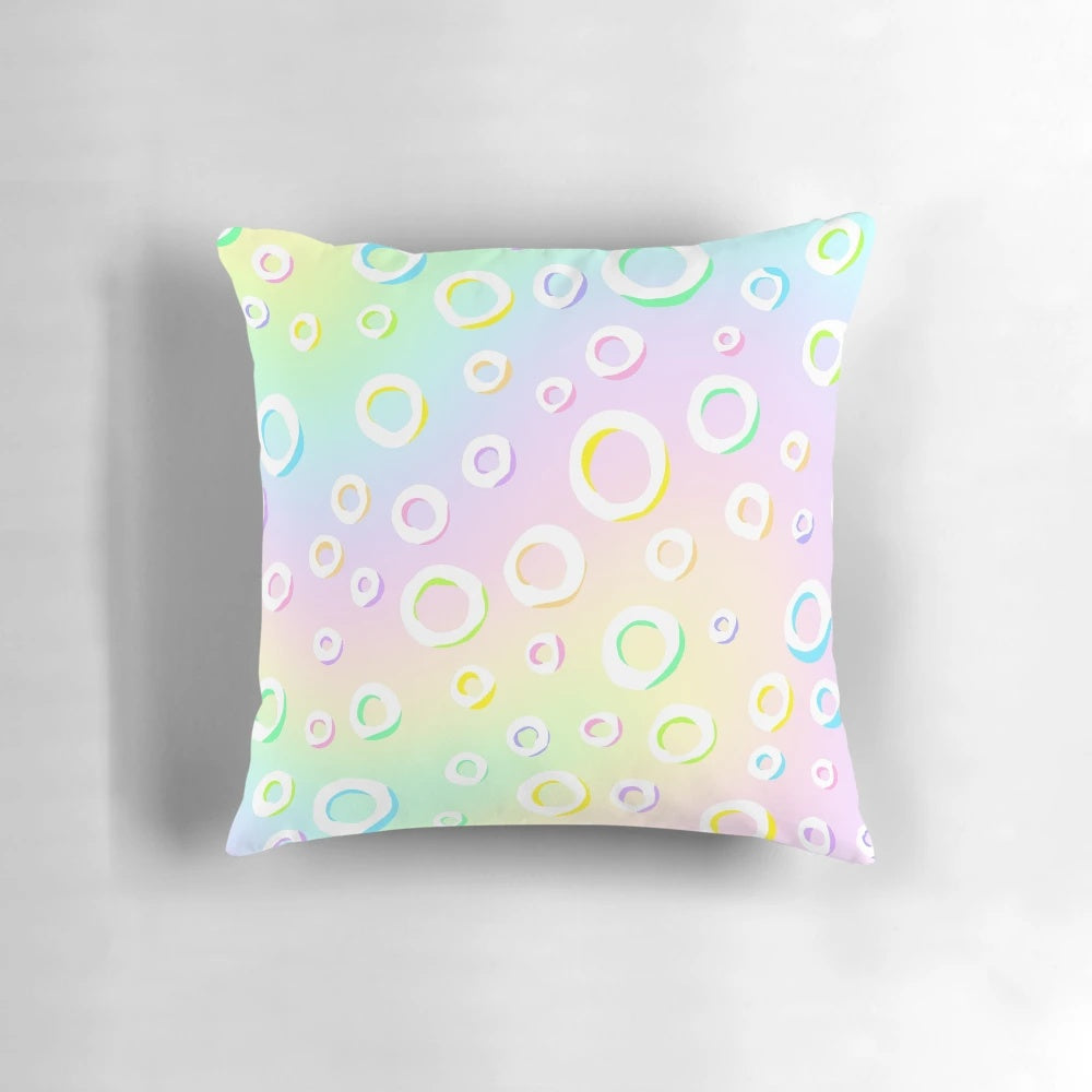 Pastel rainbow gradient design with polka dots on a decorative throw pillow
