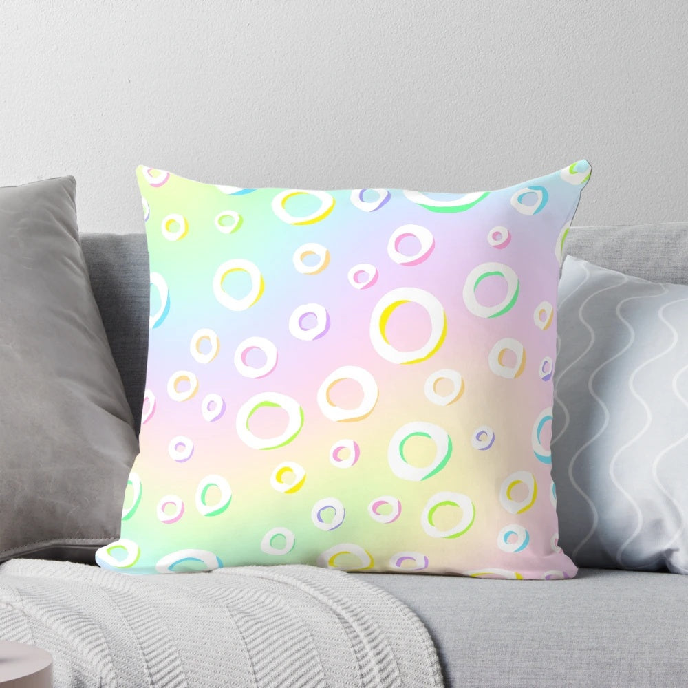 Pastel rainbow gradient design with polka dots on a decorative throw pillow