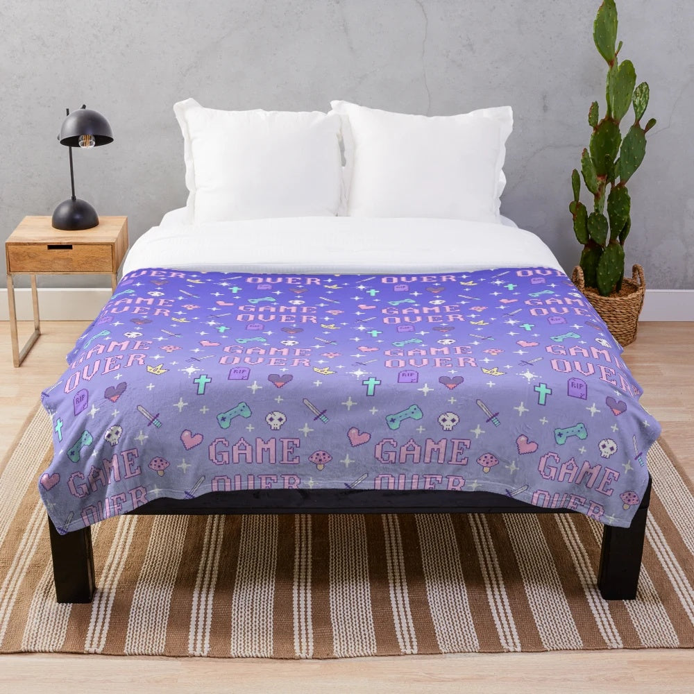 Soft pastel-colored plush blanket with retro video game pixel art design