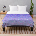 Soft pastel-colored plush blanket with retro video game pixel art design