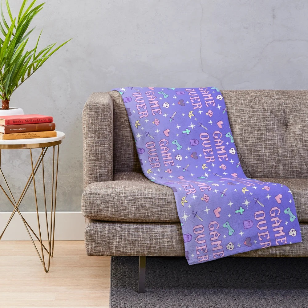 Soft pastel-colored plush blanket with retro video game pixel art design