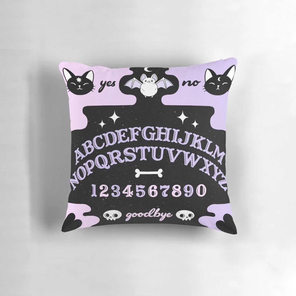 Soft pastel-colored Ouija board-inspired throw pillow with a cat and bat silhouette, perfect for witchy or pagan home decor.