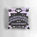 Soft pastel-colored Ouija board-inspired throw pillow with a cat and bat silhouette, perfect for witchy or pagan home decor.
