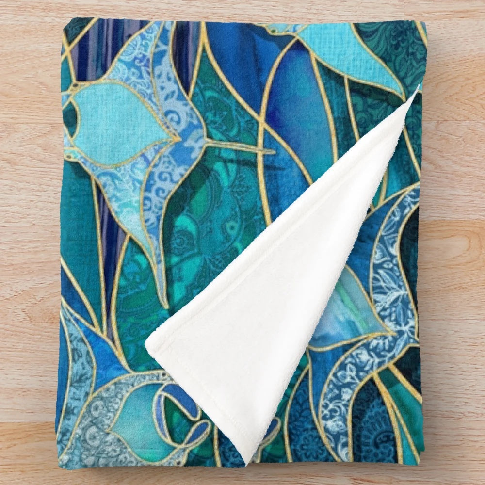 Patchwork manta ray design plush blanket in shades of blue and turquoise