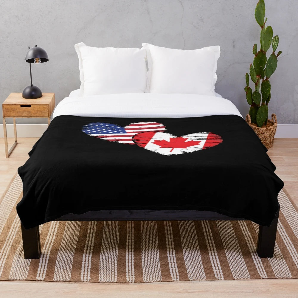 Plush blanket featuring the Canadian flag, maple leaf, and moose