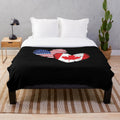 Plush blanket featuring the Canadian flag, maple leaf, and moose