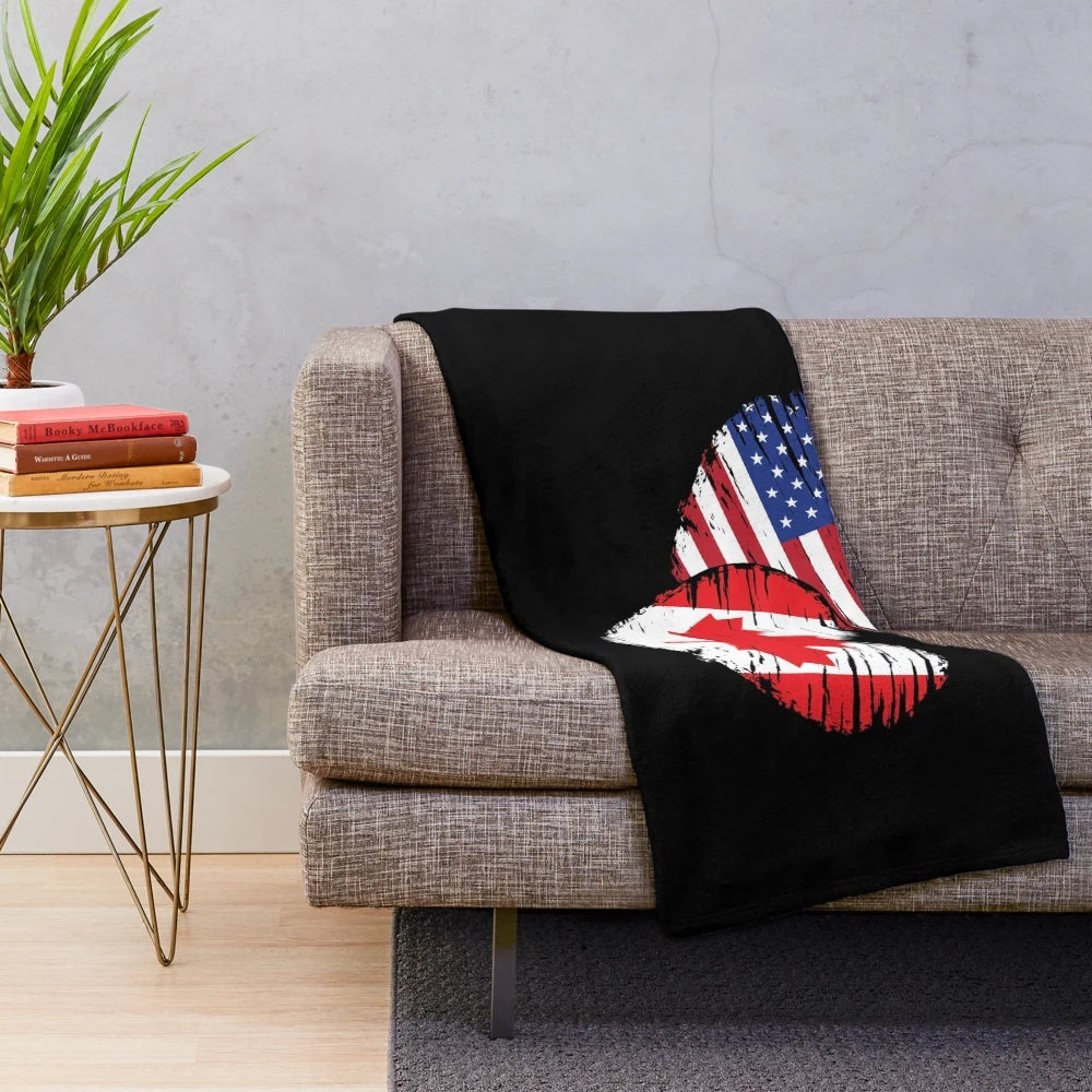 Plush blanket featuring the Canadian flag, maple leaf, and moose