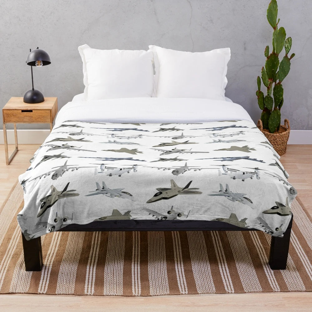 Plush blanket with a variety of military aircraft and patriotic designs