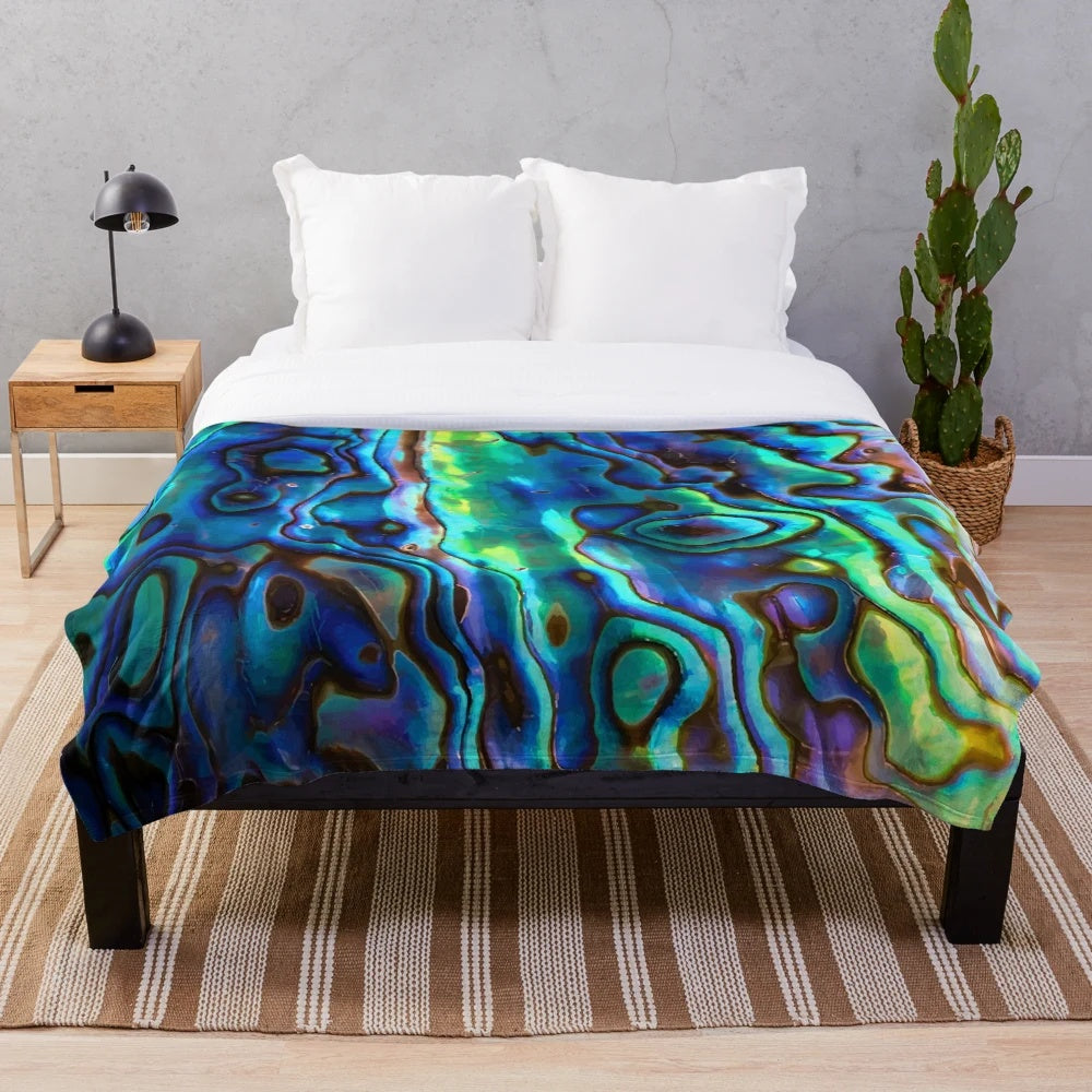 Paua shell inspired plush blanket with kiwi design