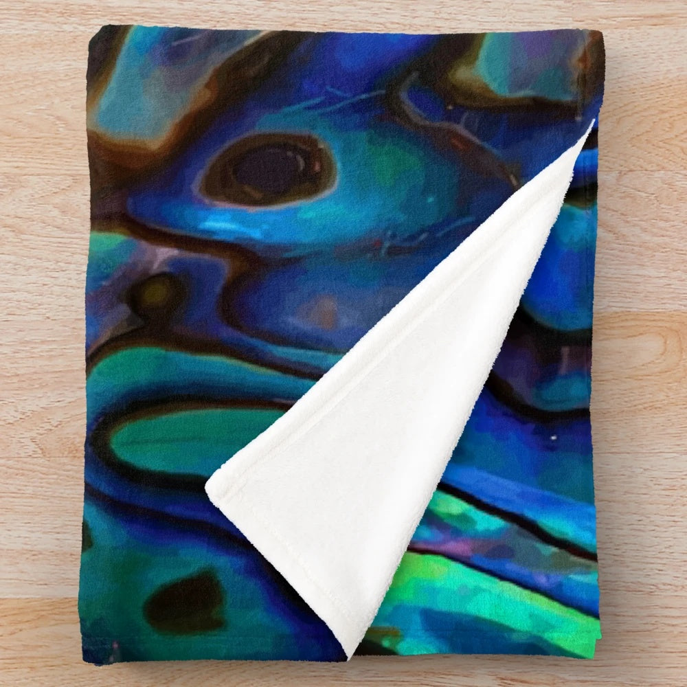 Paua shell inspired plush blanket with kiwi design