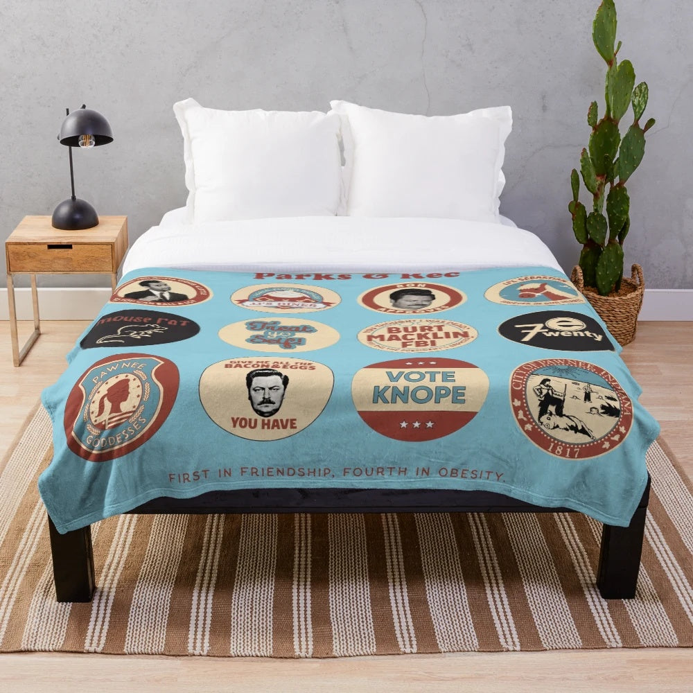 Parks and Recreation-themed plush blanket featuring Ron Swanson and Pawnee iconography