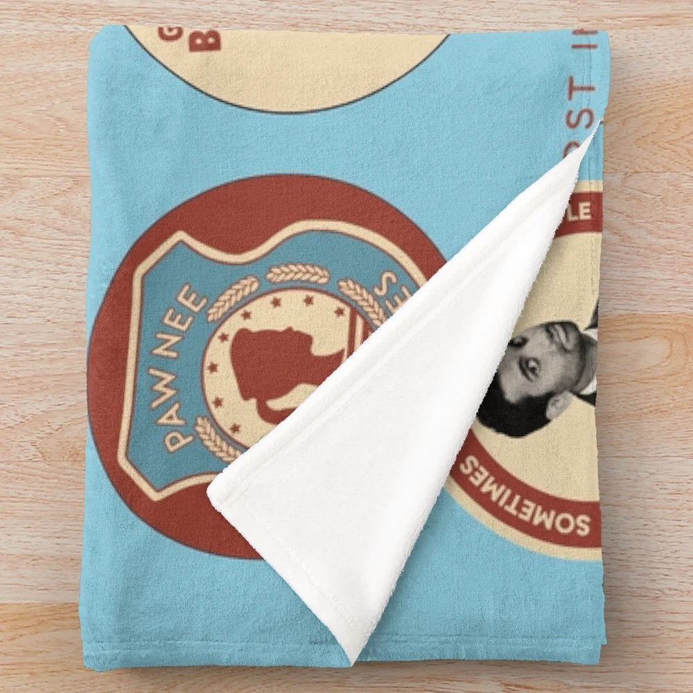 Parks and Recreation-themed plush blanket featuring Ron Swanson and Pawnee iconography