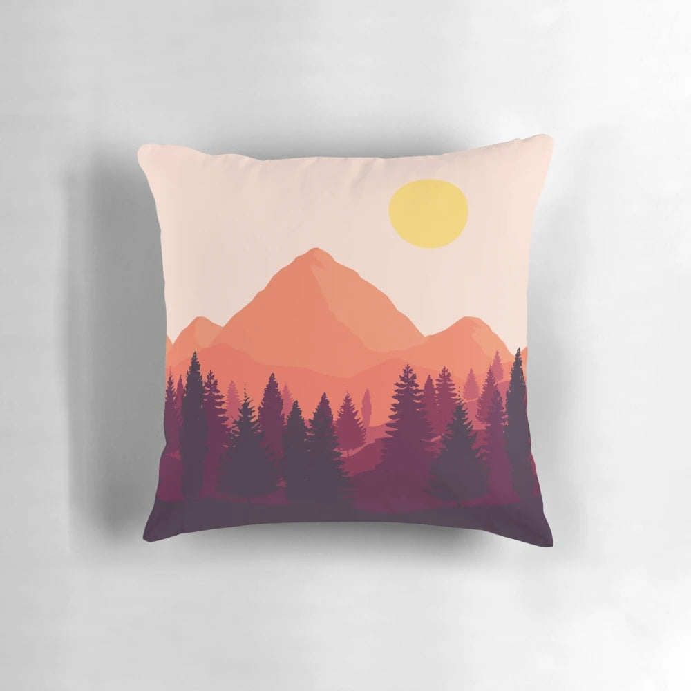 A soft, plush pillow featuring a scenic mountain landscape at sunset.