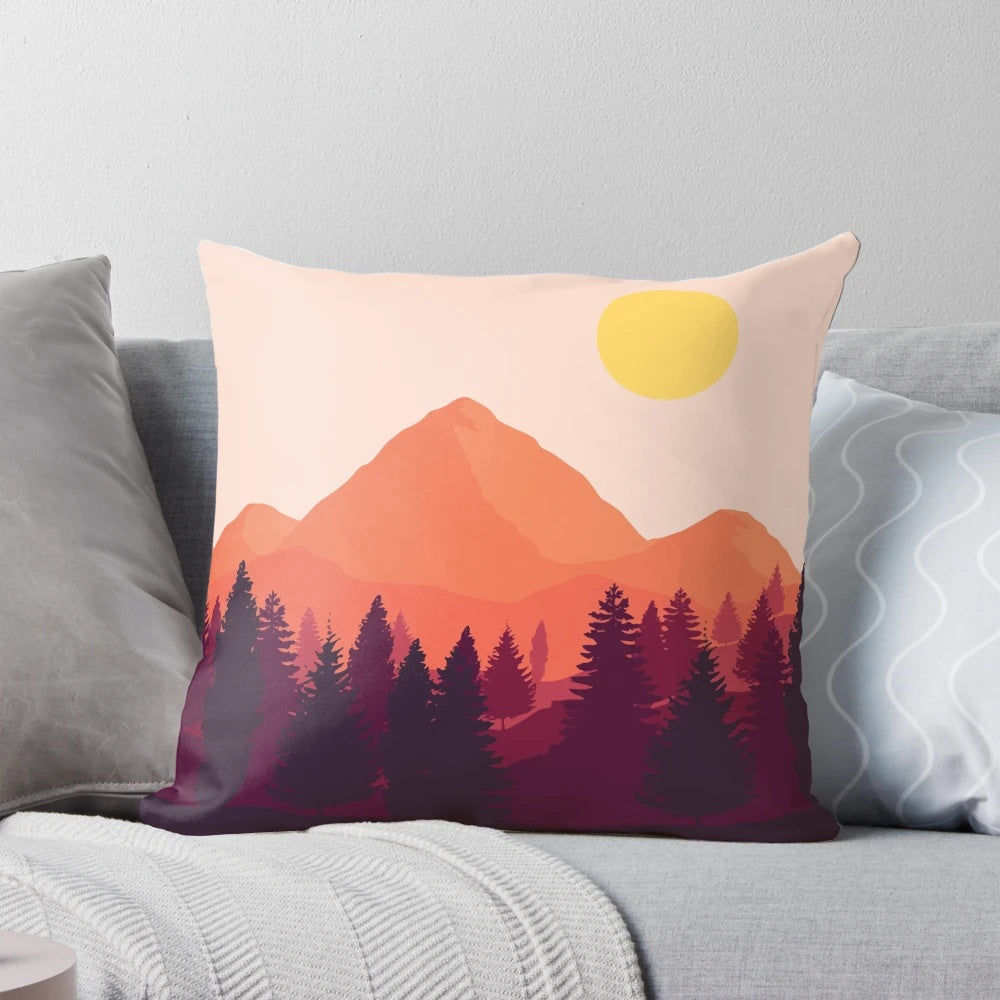 A soft, plush pillow featuring a scenic mountain landscape at sunset.
