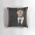 A cozy throw pillow featuring a portrait of Thomas "Tommy" Shelby, the iconic character from the Peaky Blinders TV series, played by actor Cillian Murphy.