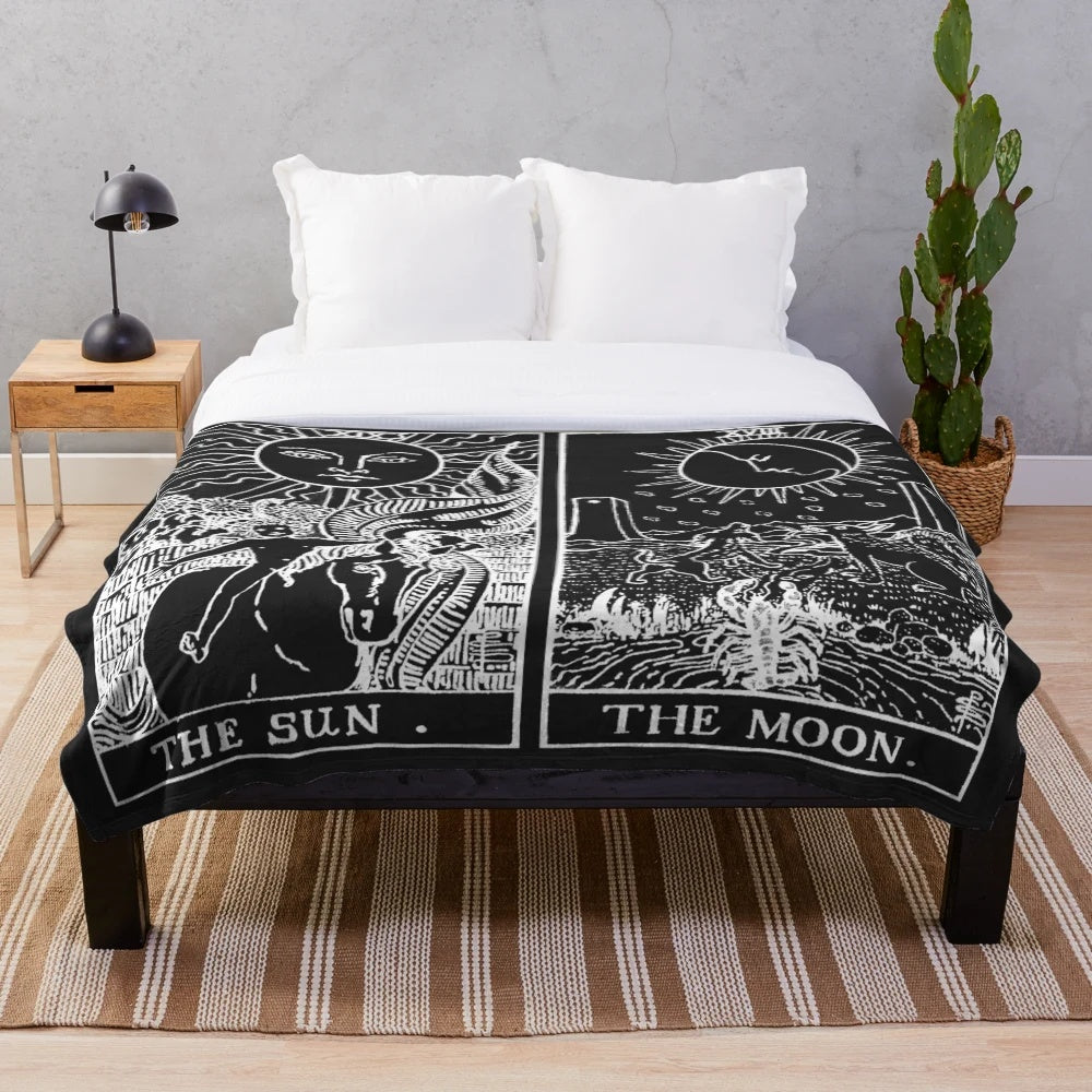 Plush blanket featuring a sun and moon tarot card design in pearl and obsidian colors