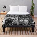 Plush blanket featuring a sun and moon tarot card design in pearl and obsidian colors