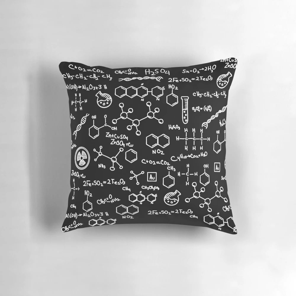 A decorative throw pillow featuring a pattern of chemical element symbols from the periodic table.