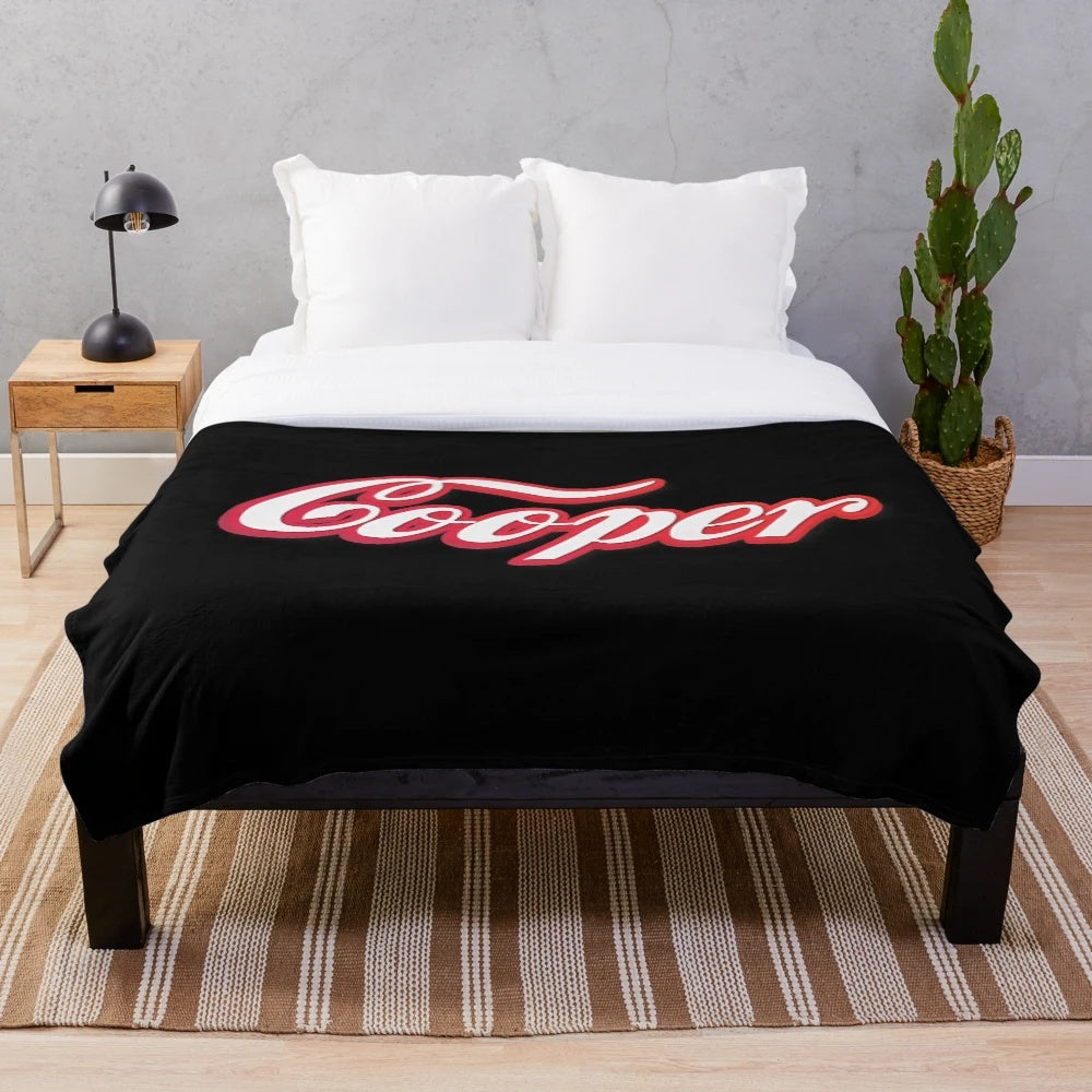 Plush dog blanket with Cooper written in white script and red outline