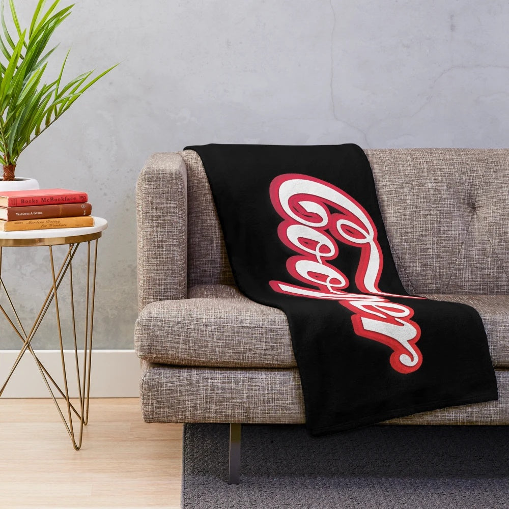 Plush dog blanket with Cooper written in white script and red outline