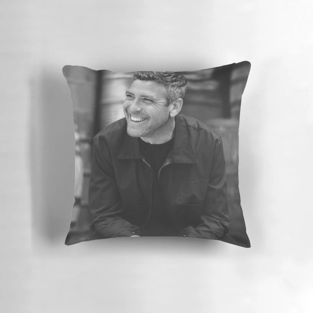 Closeup of a large, plush pillow featuring a photo of George Clooney's face