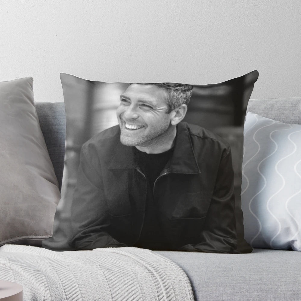 Closeup of a large, plush pillow featuring a photo of George Clooney's face