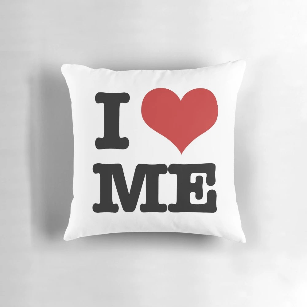 A heart-shaped pillow with the text "I Love Me" printed on it, representing self-love and self-care.