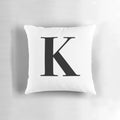 Closeup of a soft, plush throw pillow with the letter K monogrammed in the center