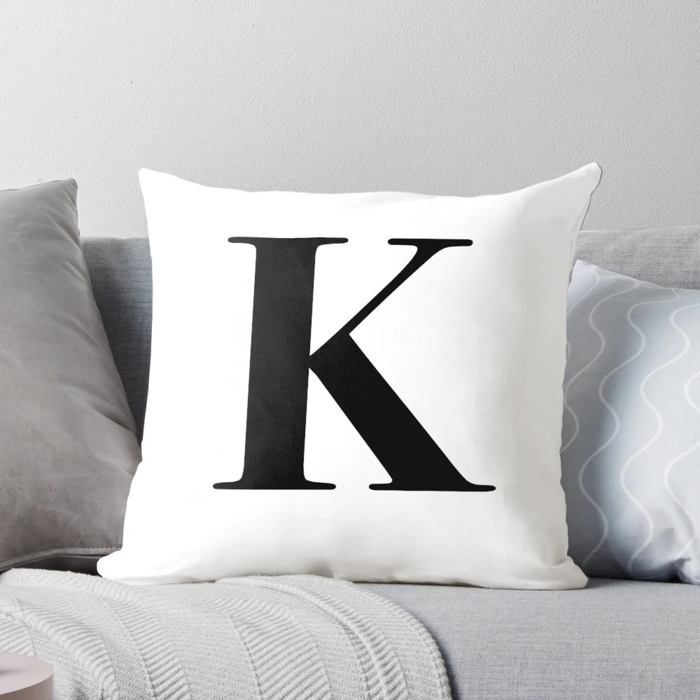 Closeup of a soft, plush throw pillow with the letter K monogrammed in the center