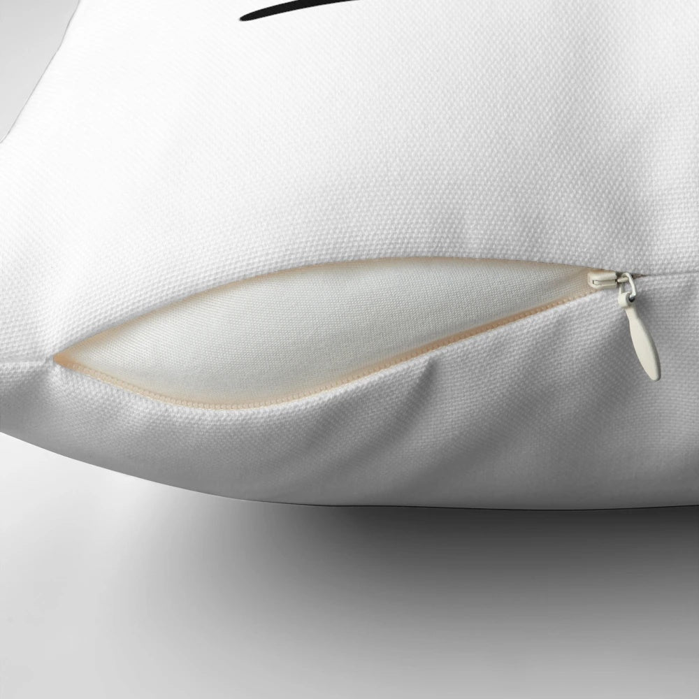 Closeup of a soft, plush throw pillow with the letter K monogrammed in the center