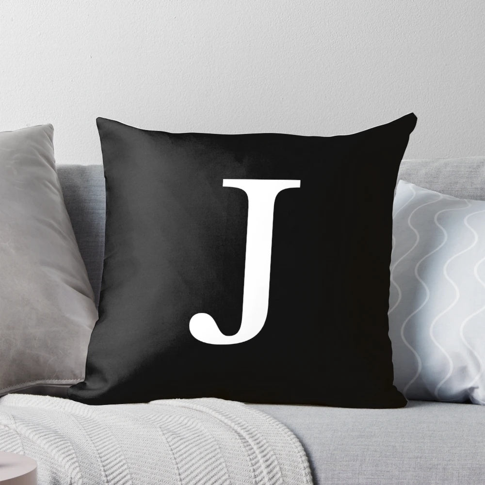 Black and white monogram initial J pillow with a minimalist, classy design.