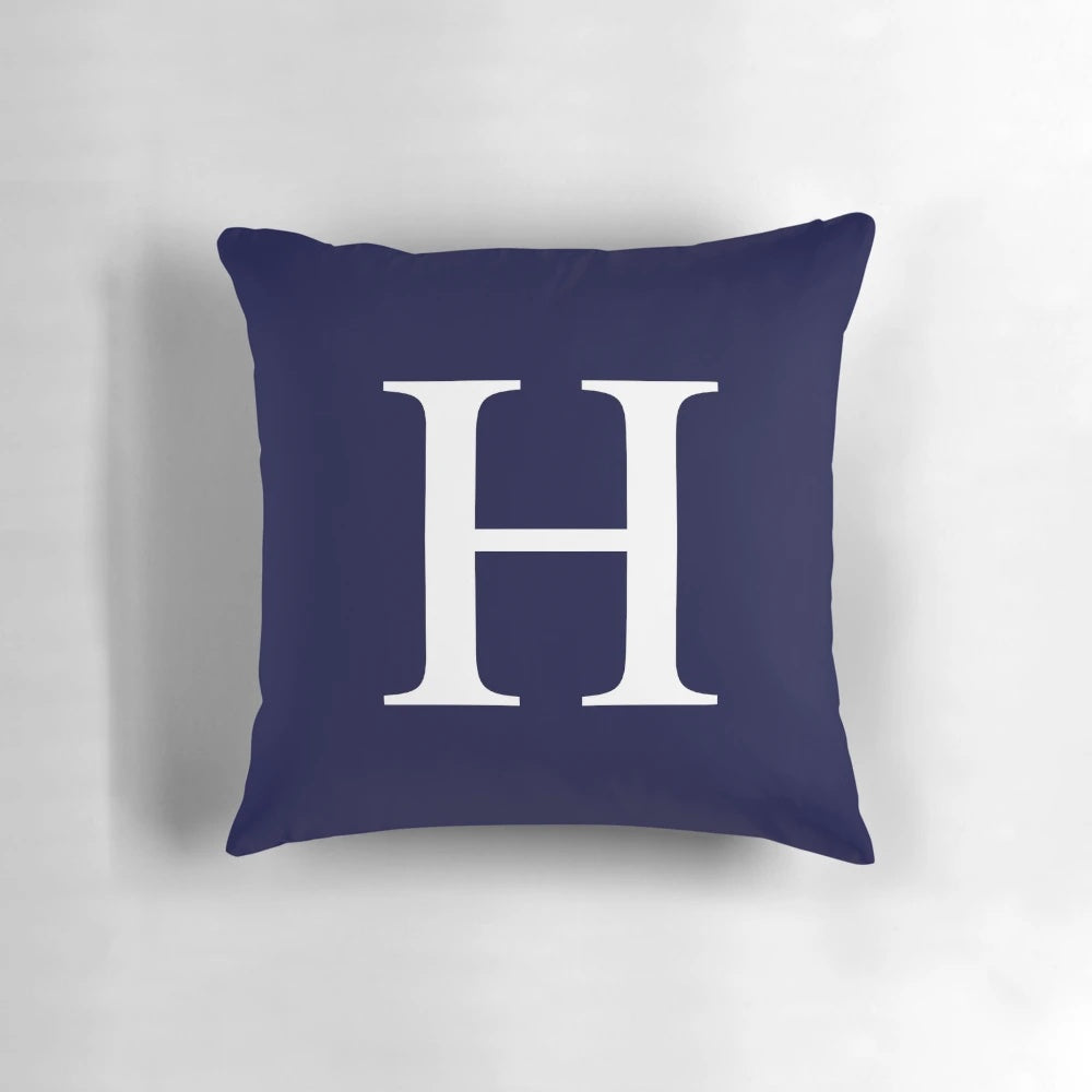 Navy blue and white pillow with monogram H design, ideal for personalized and minimal home decor