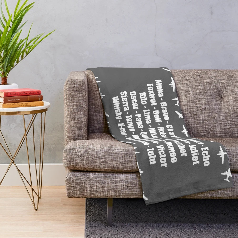 Phonetic alphabet plush blanket featuring a white airplane design